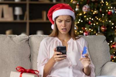 woman in santa hat with phone